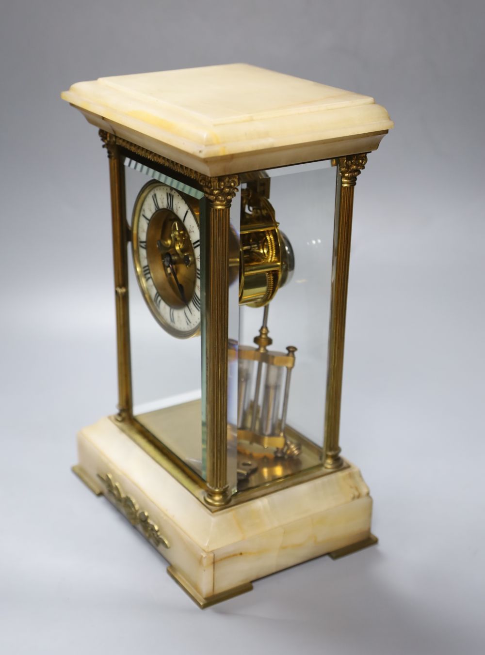 An early 20th century French brass and onyx four glass clock